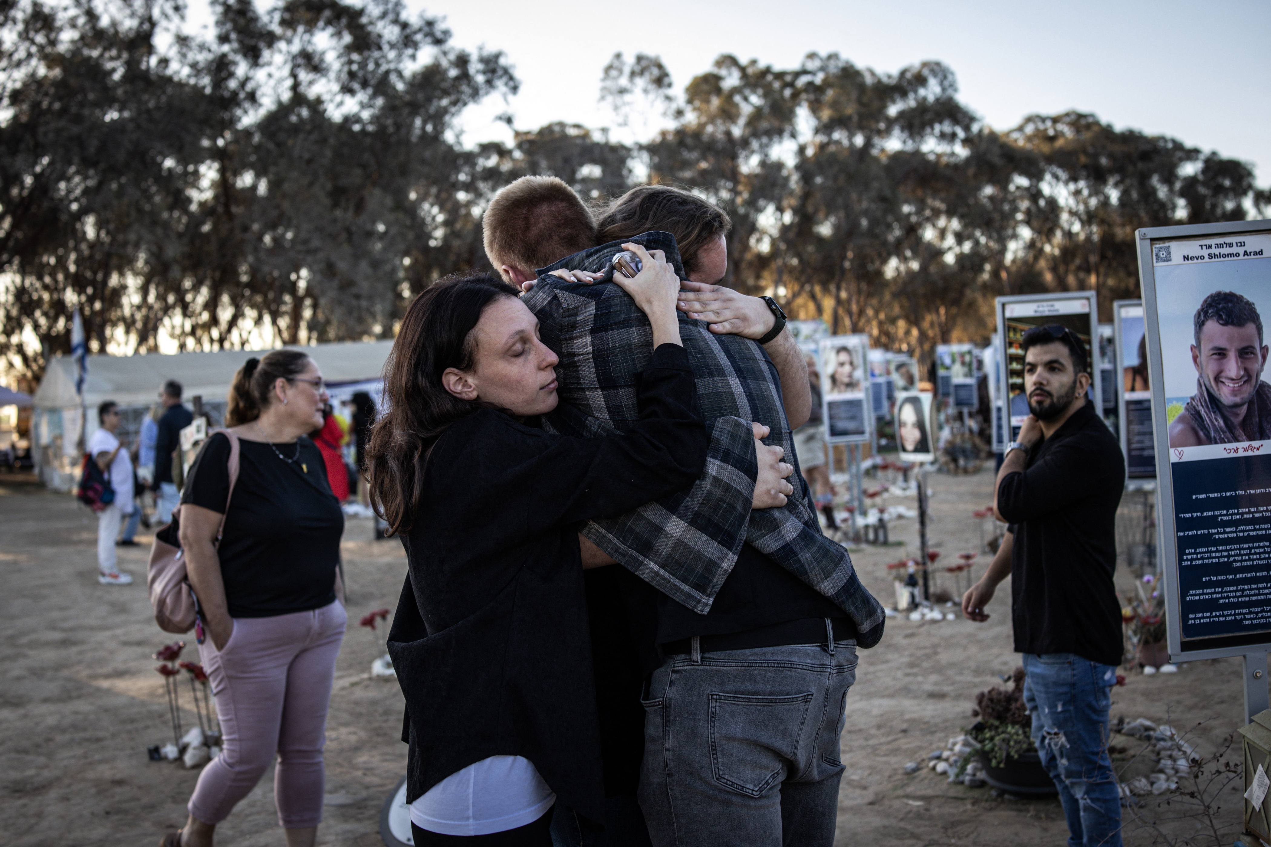 People embrace next to memorials of victims of the Oct. 7, 2023, attacks at the Nova Festival grounds in Reim, in southern Israel, on the second anniversary of the Hamas-led attacks on Tuesday.